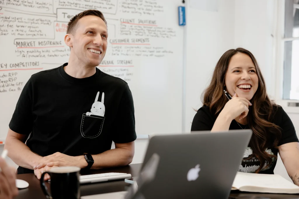 White Rabbit team smiling and discussing copywriting tips