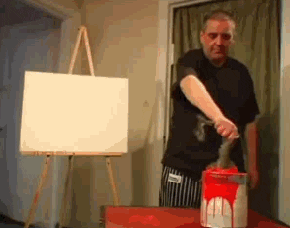 man splattering paint on canvas funny art GIF